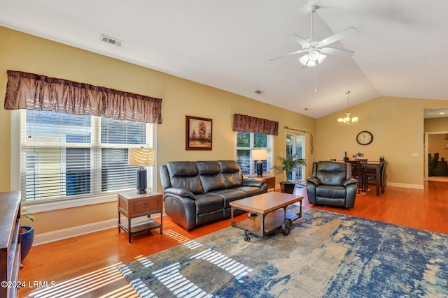 living room featuring hardwood / wood-style flooring, vaulted ceiling, and ceiling fan with notable chandelier