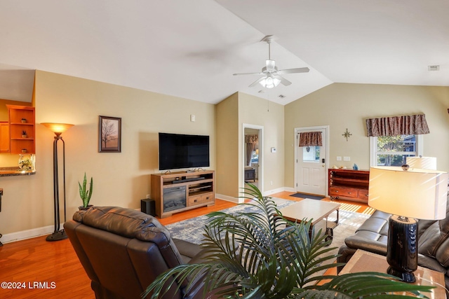 living room with hardwood / wood-style flooring, lofted ceiling, and ceiling fan