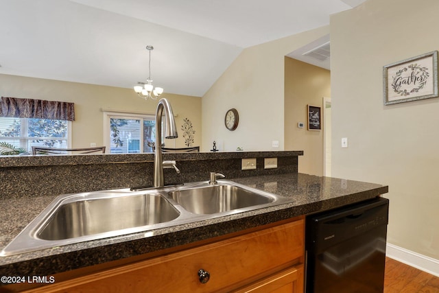 kitchen featuring lofted ceiling, sink, decorative light fixtures, dishwasher, and hardwood / wood-style flooring