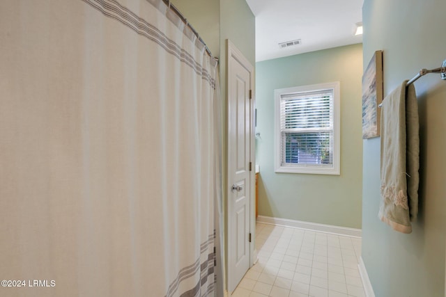 bathroom with tile patterned floors