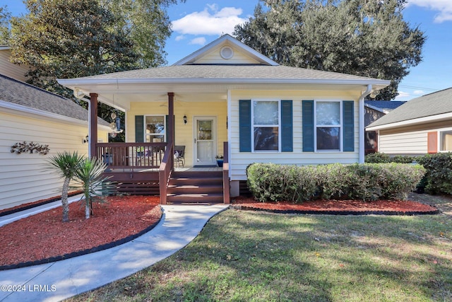 bungalow-style house featuring a front yard and covered porch