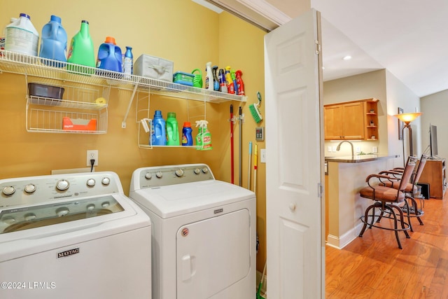 washroom with washer and dryer and light wood-type flooring