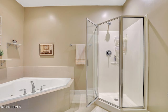 bathroom with independent shower and bath and tile patterned flooring