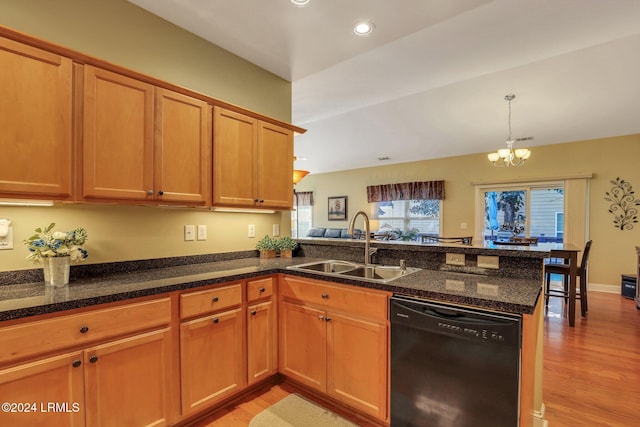 kitchen with black dishwasher, sink, kitchen peninsula, and light wood-type flooring