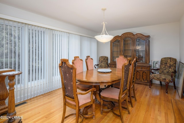 dining space with light hardwood / wood-style floors