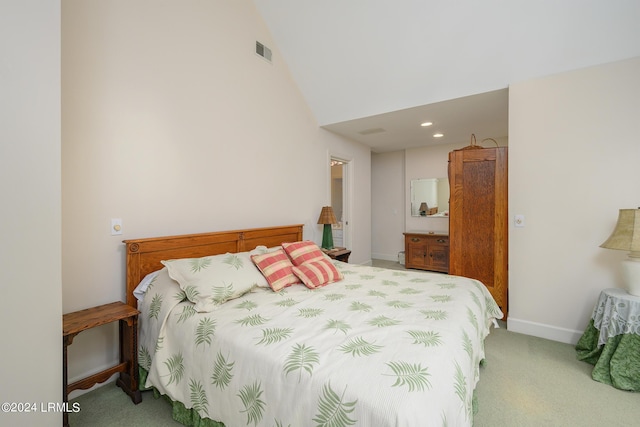 bedroom featuring lofted ceiling and light colored carpet