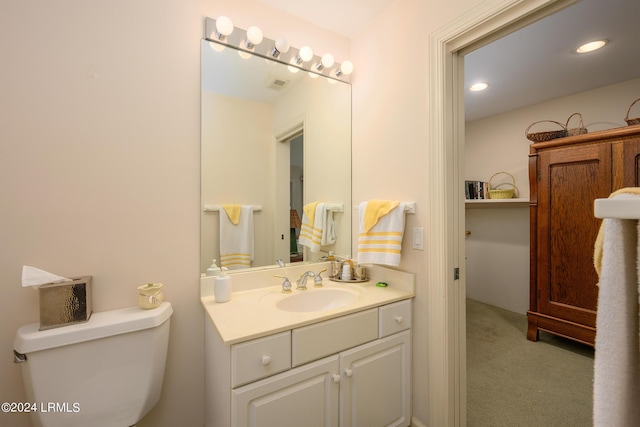 bathroom featuring vanity and toilet