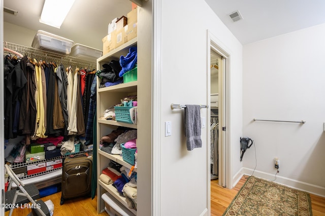 spacious closet featuring light hardwood / wood-style floors