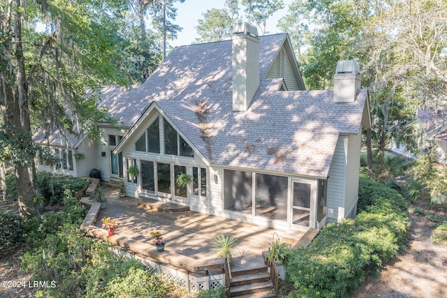 rear view of house featuring a deck