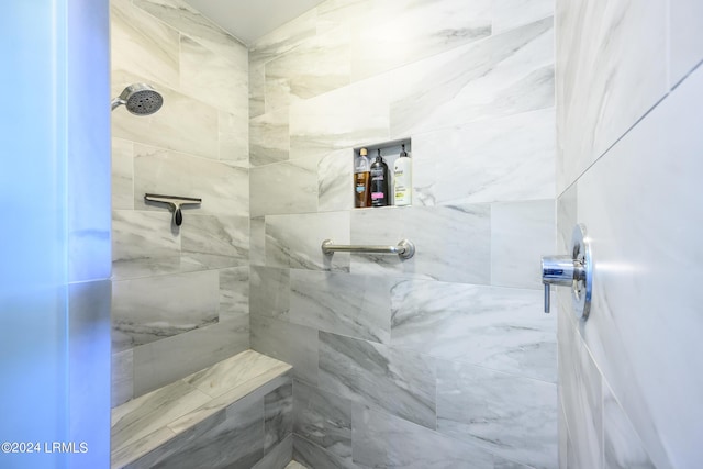 bathroom with tiled shower