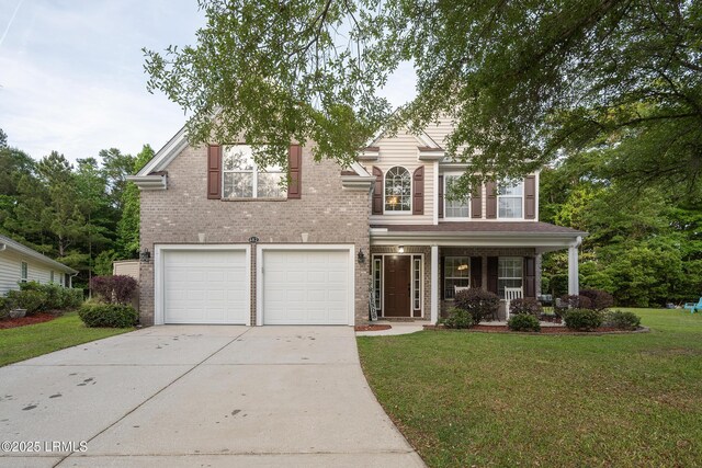 482 Live Oak Walk, Bluffton, SC 29910 - traditional-style home featuring a front lawn, brick siding, a garage, covered porch, and driveway