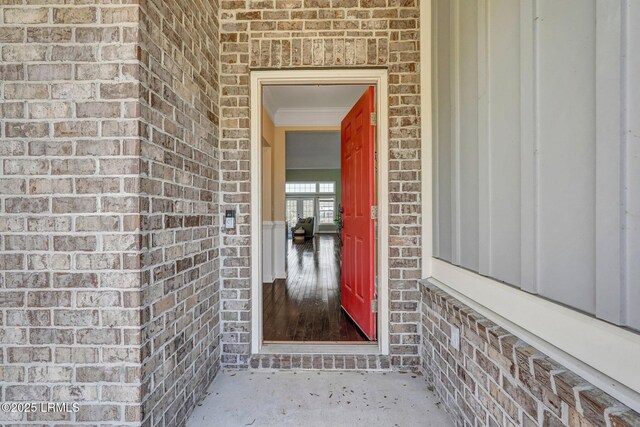 view of exterior entry with brick siding