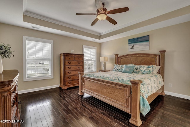 bedroom featuring visible vents, baseboards, a raised ceiling, and dark wood-type flooring