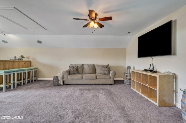 carpeted living area with visible vents, lofted ceiling, a ceiling fan, baseboards, and attic access