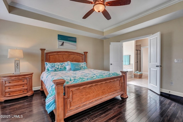 bedroom with a tray ceiling, crown molding, baseboards, and dark wood-style flooring