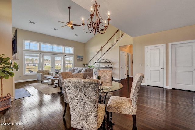 dining room with baseboards, visible vents, high vaulted ceiling, dark wood-style flooring, and ceiling fan with notable chandelier