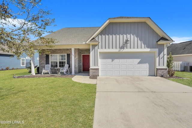 view of front of home with driveway, board and batten siding, an attached garage, a front yard, and brick siding