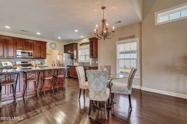 dining room with visible vents, baseboards, recessed lighting, dark wood-type flooring, and a notable chandelier