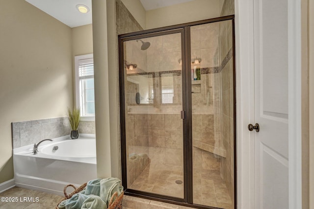 bathroom featuring a stall shower and a garden tub