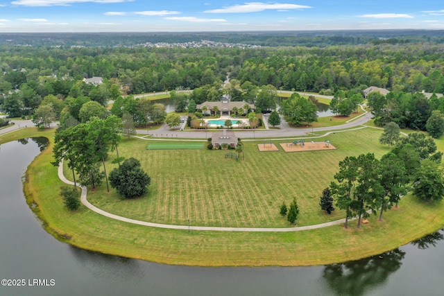 aerial view with a forest view and a water view