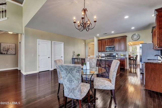 dining room with recessed lighting, dark wood-style floors, baseboards, and a chandelier