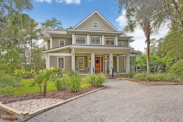 view of front of property featuring a porch, a standing seam roof, and metal roof