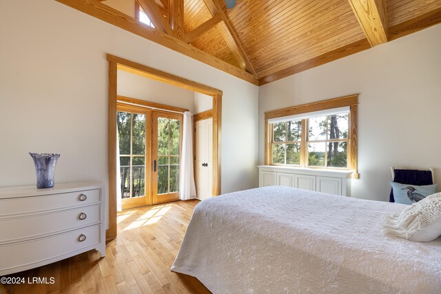 bedroom featuring lofted ceiling with beams, wooden ceiling, access to exterior, french doors, and light wood-type flooring