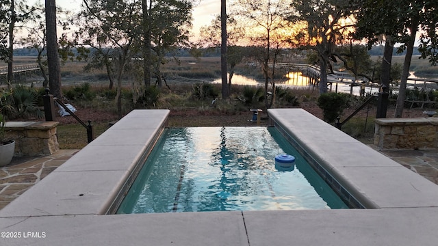 pool at dusk with a pool