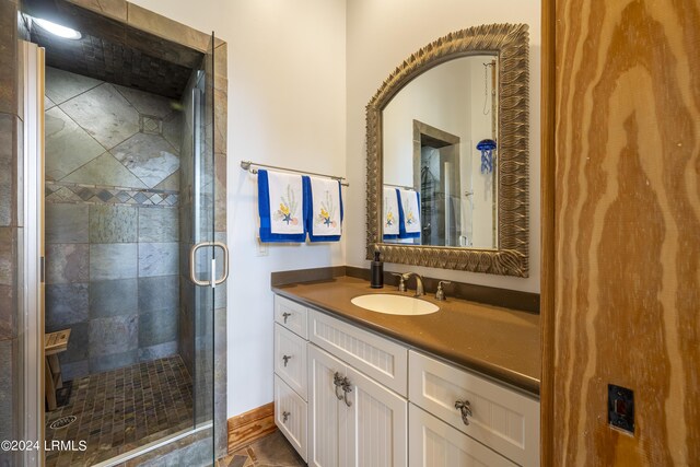 bathroom featuring a stall shower and vanity