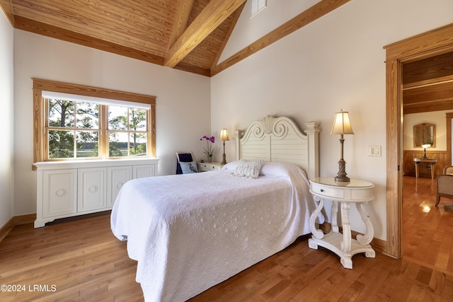 bedroom with wood ceiling, visible vents, baseboards, light wood-type flooring, and beam ceiling