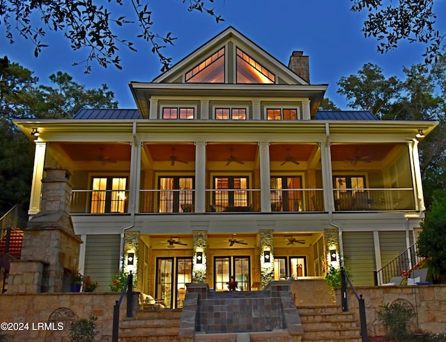 back of property with french doors, metal roof, stairway, and a standing seam roof