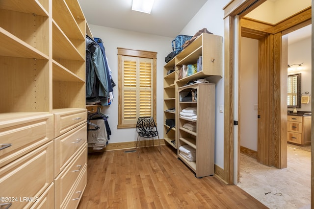 walk in closet featuring light wood finished floors