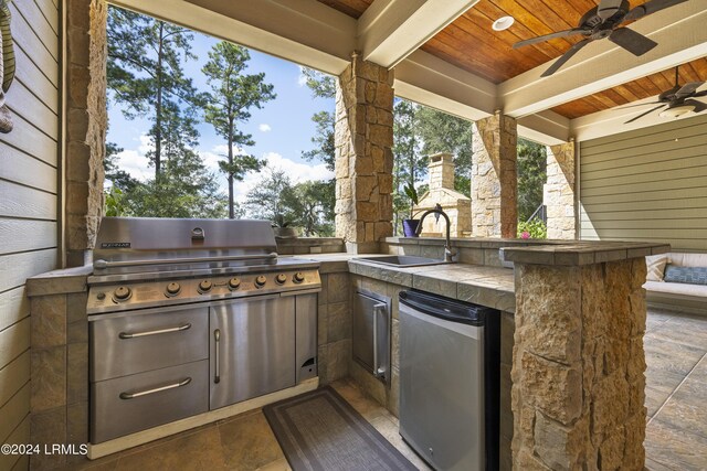 view of patio / terrace featuring exterior kitchen, a grill, a sink, and ceiling fan