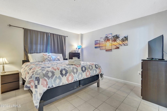 bedroom featuring a textured ceiling and light tile patterned flooring