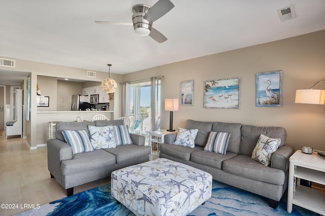 living room with ceiling fan and light hardwood / wood-style floors