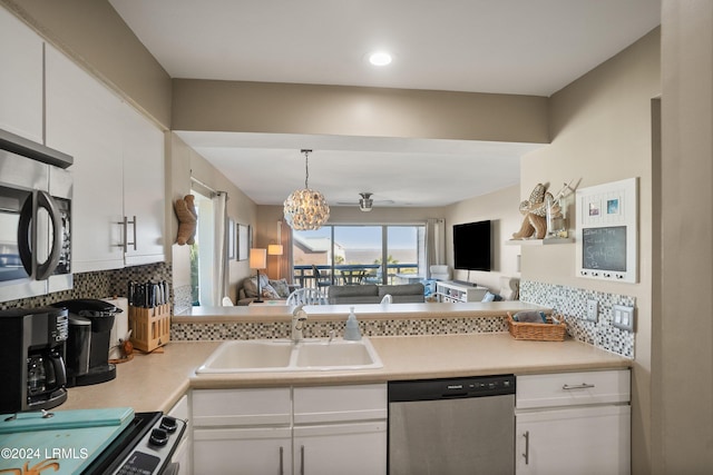 kitchen with white cabinetry, appliances with stainless steel finishes, sink, and pendant lighting