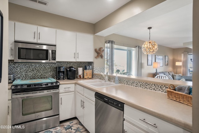 kitchen featuring tasteful backsplash, stainless steel appliances, sink, and white cabinets