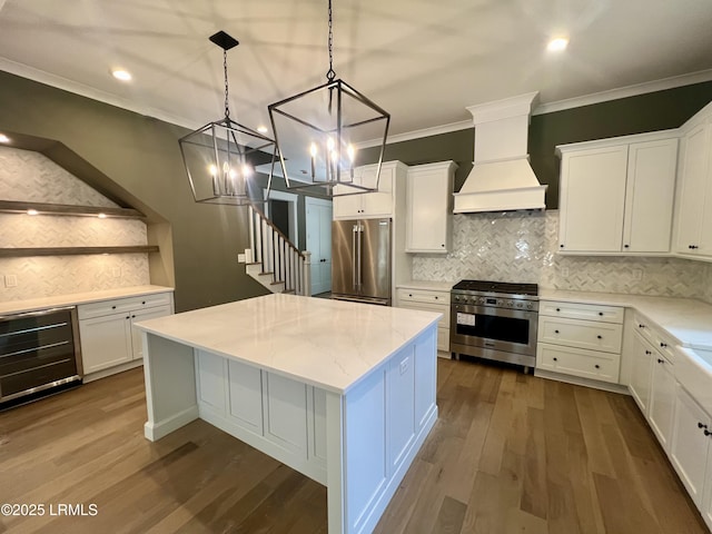 14 Heron Pt, Okatie, SC 29909 - kitchen with premium appliances, custom range hood, a center island, ornamental molding, and beverage cooler