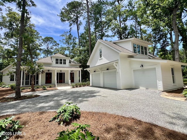 14 Heron Pt, Okatie, SC 29909 - view of front of house with gravel driveway, a porch, and a shingled roof