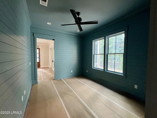 14 Heron Pt, Okatie, SC 29909 - unfurnished bedroom with multiple windows, wooden walls, recessed lighting, and a ceiling fan