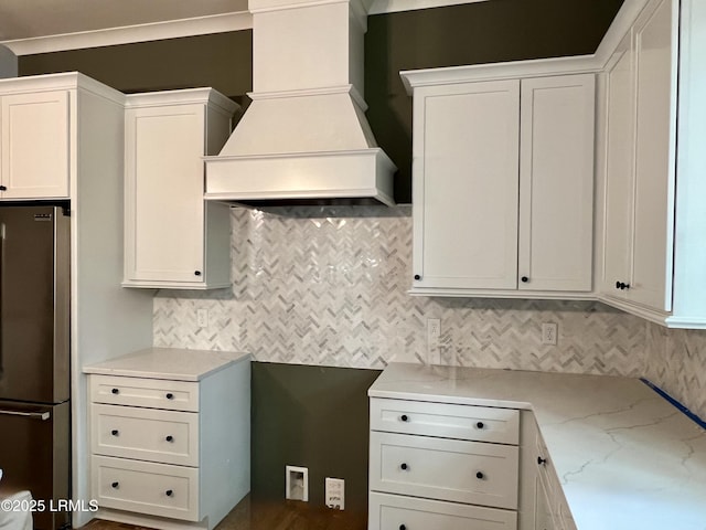 14 Heron Pt, Okatie, SC 29909 - kitchen featuring freestanding refrigerator, premium range hood, tasteful backsplash, and light stone countertops