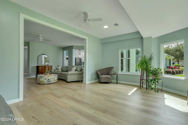 sitting room with ceiling fan and light hardwood / wood-style flooring