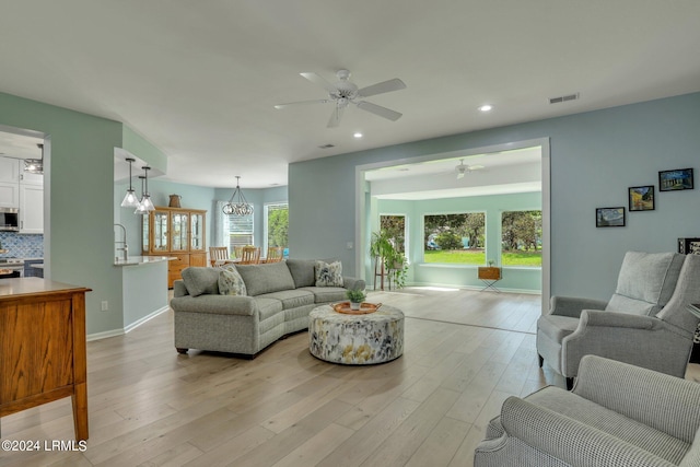 living room featuring light hardwood / wood-style floors and ceiling fan