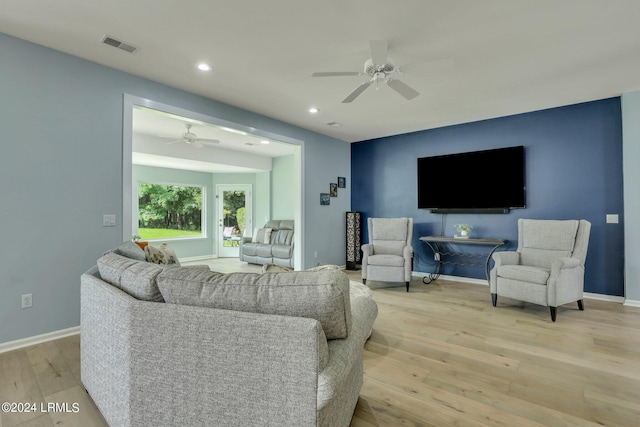 living room featuring ceiling fan and light hardwood / wood-style floors