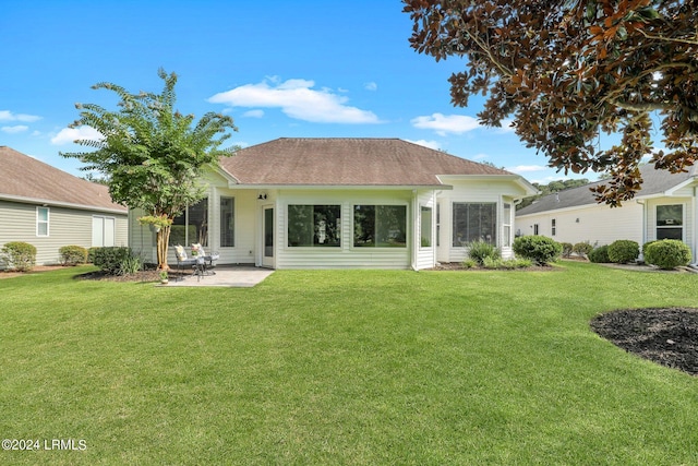 rear view of house featuring a patio area and a lawn