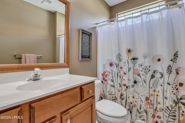 bathroom with vanity, a shower with curtain, and toilet