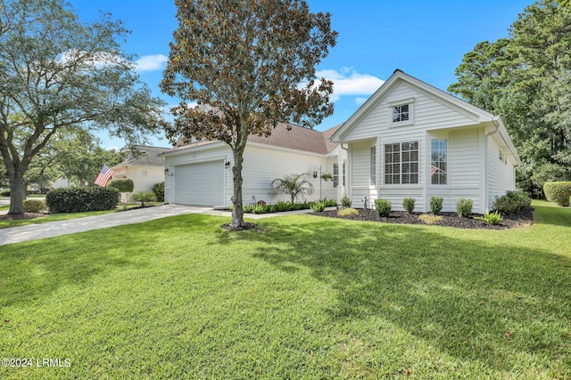 view of front of house with a garage and a front yard