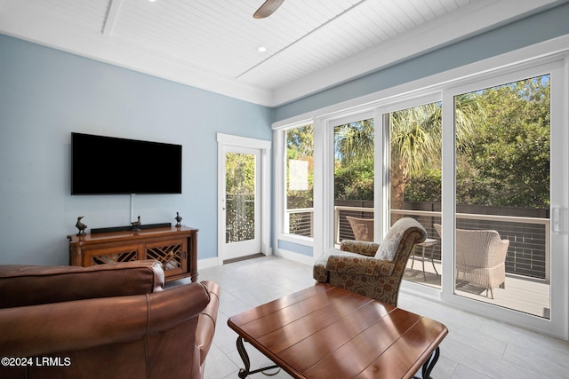 sunroom with ceiling fan and wooden ceiling