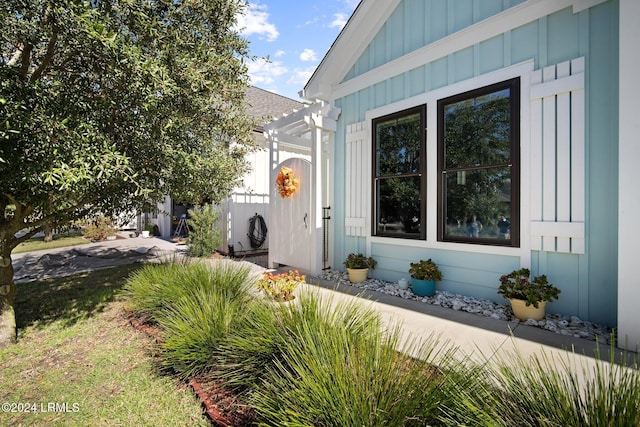 doorway to property featuring a pergola