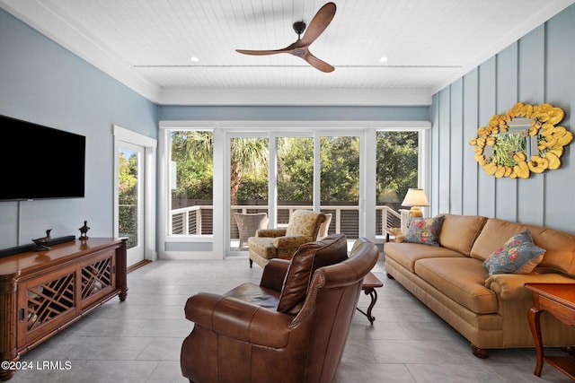 living room featuring ceiling fan, wood ceiling, and a healthy amount of sunlight